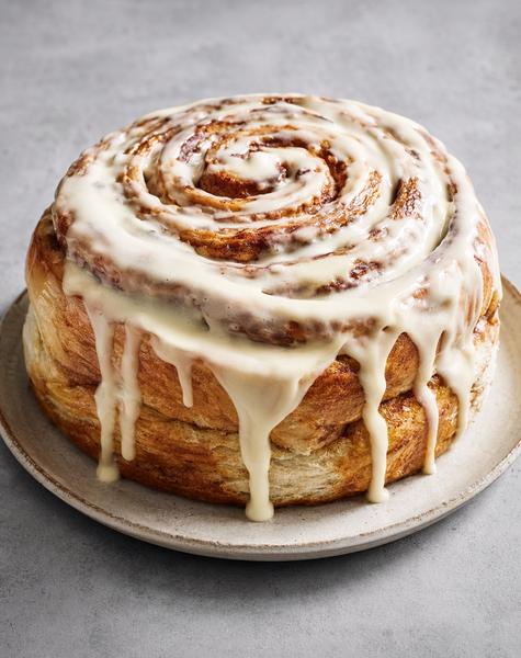 Cinnamon roll styled on a clean, uncluttered surface